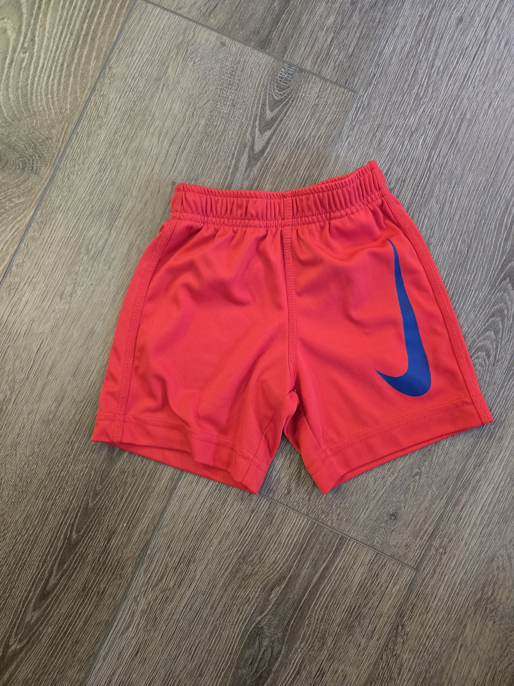 Nike Red Kids Athletic Shorts with Blue Swoosh Accent